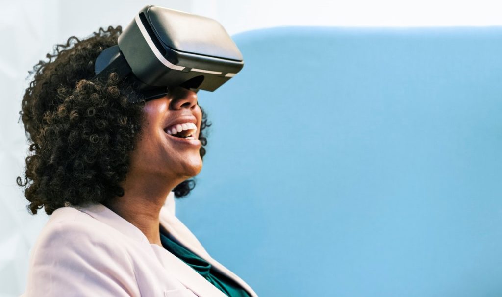 Woman with VR headset laughing