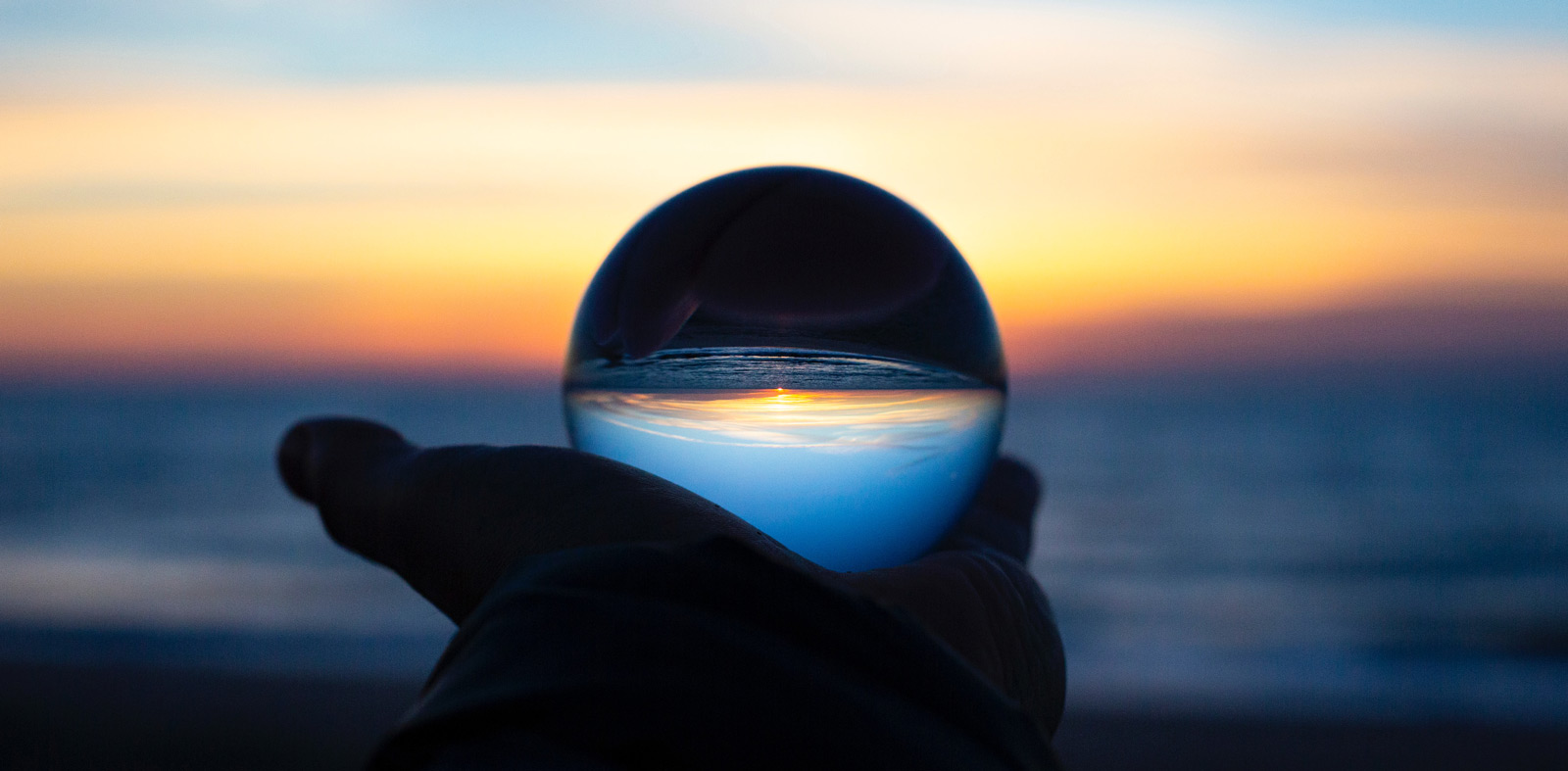 Man holding a crystal ball in his hand