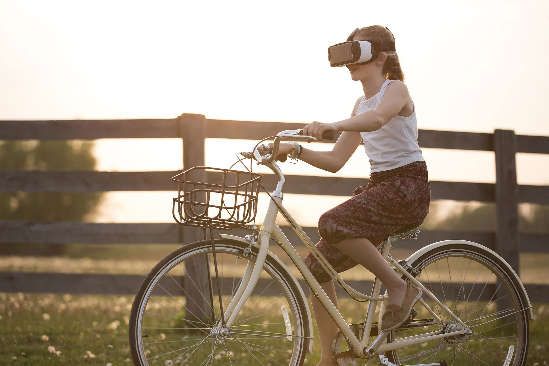 A girl wearing VR glasses while on a bicycle